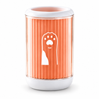 A cylindrical pet toy or container with a ribbed translucent orange body, white top and base, and a white dog silhouette graphic on the front, shown on a clean white background.