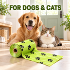 A golden retriever and a tabby cat sit indoors on a rug beside a rolled green pet training mat with black paw-print pattern. Large text at the top reads “FOR DOGS & CATS.