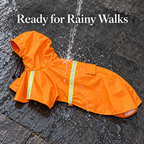 An orange hooded raincoat for pets is shown outdoors on wet dark pavement with water pouring over it. Large white text at the top reads 'Ready for Rainy Walks.