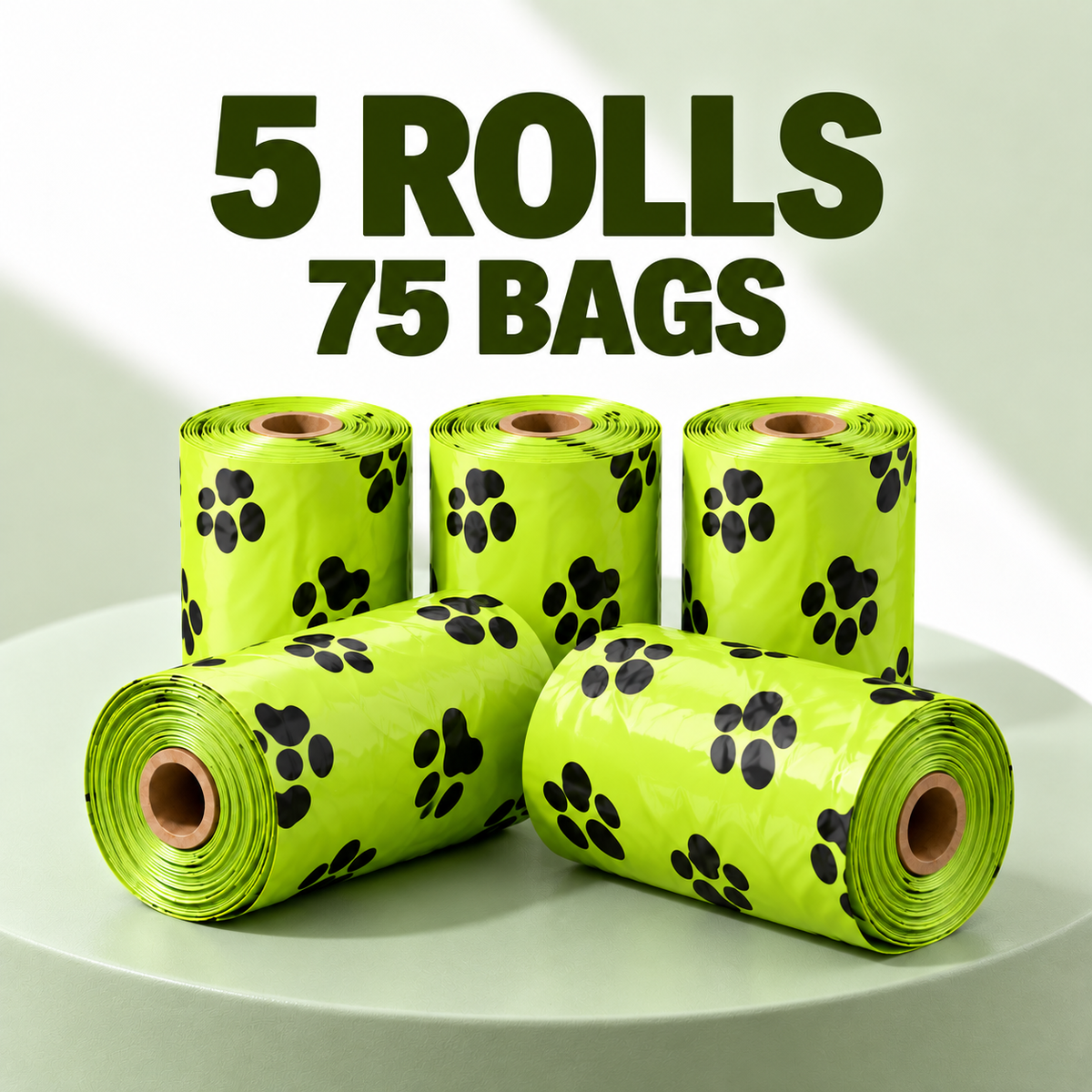 Five rolls of bright lime green dog waste bags with black paw print patterns, arranged on a light green surface. Large dark green text at the top reads '5 ROLLS 75 BAGS'.