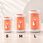 Three pet poop bags in sizes S, M, and L lined up on a light beige countertop. The bags have a ribbed orange design with a white dog silhouette and paw print, clear sides, and white lids and bases.