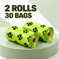 Two rolls of bright lime green pet waste bags with black paw print patterns, displayed on a light green pedestal with text overlay reading '2 ROLLS 30 BAGS'.